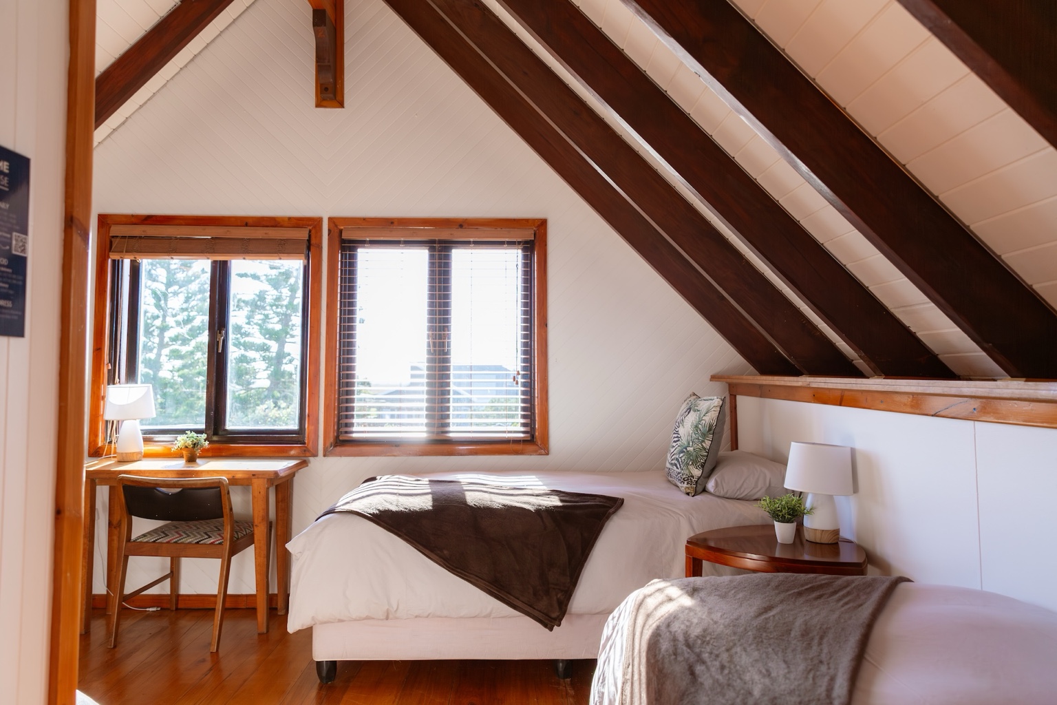 A sleek wardrobe with ample storage, a mirror, and a comfortable reading corner.